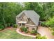 Charming traditional home with manicured lawn, stone accents, and a welcoming front porch at 106 Stephens Farm Dr, Canton, GA 30115