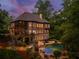 Beautiful home with pool, patio, screened porch, and lush landscaping in a serene wooded setting at 106 Stephens Farm Dr, Canton, GA 30115