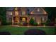 Beautiful home exterior with a stone facade, covered porch, manicured lawn, and mature landscaping at 106 Stephens Farm Dr, Canton, GA 30115
