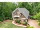 Traditional two-story home with stone and brick accents, a covered front porch, and mature landscaping at 106 Stephens Farm Dr, Canton, GA 30115