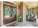 Inviting front porch with double doors, brick accents, and seating area at 106 Stephens Farm Dr, Canton, GA 30115