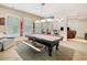 This game room features a billiard table with a drawer containing game supplies and an adjacent sitting area with a bar at 106 Stephens Farm Dr, Canton, GA 30115