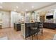 Bright kitchen features a kitchen island, stainless steel appliances, and bar stool seating at 106 Stephens Farm Dr, Canton, GA 30115