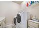 Laundry room with white washer and dryer, storage cabinets and countertops at 106 Stephens Farm Dr, Canton, GA 30115