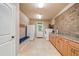 Large, bright laundry room with modern appliances, sink, ample counter space, and access to the backyard at 106 Stephens Farm Dr, Canton, GA 30115