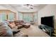 The living room has a large, comfortable leather sofa and entertainment center, providing a relaxing gathering space at 106 Stephens Farm Dr, Canton, GA 30115