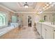Luxurious main bathroom with soaking tub, glass-enclosed shower, and dual vanities at 106 Stephens Farm Dr, Canton, GA 30115