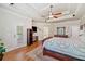 Main bedroom featuring hardwood floors, tray ceiling, access to ensuite, and a view of the backyard at 106 Stephens Farm Dr, Canton, GA 30115