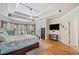 A sun-filled main bedroom with hardwood floors, a tray ceiling, and a ceiling fan at 106 Stephens Farm Dr, Canton, GA 30115