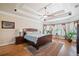 Spacious main bedroom boasts a tray ceiling, large windows with plantation shutters, and hardwood floors at 106 Stephens Farm Dr, Canton, GA 30115
