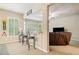 Open-concept sitting area includes bar seating and adjacent living room with a leather sofa and entertainment center at 106 Stephens Farm Dr, Canton, GA 30115
