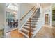 Staircase with wooden steps and wrought iron railing, located next to the dining room at 106 Stephens Farm Dr, Canton, GA 30115