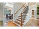 Staircase leads to the second floor with hardwood treads, iron railing, and views of the dining room at 106 Stephens Farm Dr, Canton, GA 30115