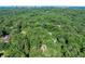 Lush aerial view showcases a wooded lot with mature trees, providing privacy and a connection to nature at 5105 Jett Forest Trl, Atlanta, GA 30327