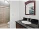 Updated bathroom with a sleek vanity, granite countertop, and tiled shower at 5105 Jett Forest Trl, Atlanta, GA 30327