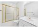 Compact bathroom with a single sink vanity and a bathtub with a sliding glass door at 5105 Jett Forest Trl, Atlanta, GA 30327