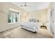 Comfortable bedroom featuring a queen-sized bed, a dormer window, and neutral carpeting at 5105 Jett Forest Trl, Atlanta, GA 30327