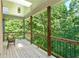Inviting covered deck with natural wood features, offering a peaceful view of lush greenery at 5105 Jett Forest Trl, Atlanta, GA 30327