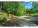 Large driveway and basketball hoop surrounded by lush greenery at 5105 Jett Forest Trl, Atlanta, GA 30327