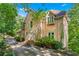An exterior view of the home exhibiting a charming, elegant facade and wooded surroundings at 5105 Jett Forest Trl, Atlanta, GA 30327
