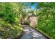 Secluded home featuring private drive surrounded by lush landscaping and mature trees at 5105 Jett Forest Trl, Atlanta, GA 30327