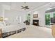 Bright main bedroom featuring a fireplace, tray ceiling, and ensuite bathroom at 5105 Jett Forest Trl, Atlanta, GA 30327