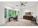 Home office with large windows, neutral carpet, and a ceiling fan at 5105 Jett Forest Trl, Atlanta, GA 30327