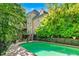 Back of house and kidney shaped pool with lush landscaping at 5105 Jett Forest Trl, Atlanta, GA 30327