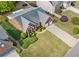 Aerial view of a brick home with a two car garage and green lawn at 1435 Harburn Ct, Cumming, GA 30041