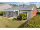 Aerial view showcasing a home's backyard with a pergola, lush lawn, and mature landscaping at 1435 Harburn Ct, Cumming, GA 30041