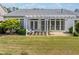 A backyard with a white pergola, a porch swing, and a well-maintained lawn at 1435 Harburn Ct, Cumming, GA 30041