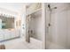 Bright bathroom showcasing separate tub and shower, white cabinets, and a large mirror at 1435 Harburn Ct, Cumming, GA 30041