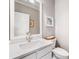 Well-lit half bathroom featuring a modern vanity, stylish mirror, and elegant finishes at 1435 Harburn Ct, Cumming, GA 30041