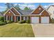 Charming brick home with a well-manicured lawn and landscaping at 1435 Harburn Ct, Cumming, GA 30041