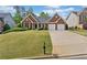 Beautiful one-story brick home with manicured lawn and a two-car garage at 1435 Harburn Ct, Cumming, GA 30041