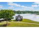 Picturesque gazebo on a grassy knoll overlooking the serene lake offers relaxation and natural beauty at 1435 Harburn Ct, Cumming, GA 30041