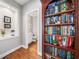 Elegant hallway with a built-in bookcase leading to a well-appointed half bathroom at 1435 Harburn Ct, Cumming, GA 30041