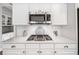 Close-up of a modern kitchen with stainless steel microwave and gas stovetop at 1435 Harburn Ct, Cumming, GA 30041