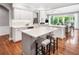 Open concept kitchen with white countertops and island seating at 1435 Harburn Ct, Cumming, GA 30041