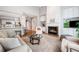 Bright open-concept living room featuring a fireplace, plush seating, and seamless access to the kitchen at 1435 Harburn Ct, Cumming, GA 30041