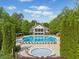 Luxury community pool with lounge chairs and a clubhouse surrounded by lush trees at 1435 Harburn Ct, Cumming, GA 30041