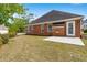Brick home with a patio and lawn in the backyard at 2055 Hickory Station Cir, Snellville, GA 30078