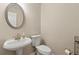 Bathroom featuring a pedestal sink, modern toilet, and decorative mirror at 2055 Hickory Station Cir, Snellville, GA 30078