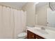Clean bathroom featuring a vanity with cabinet storage, a toilet, and a shower with a curtain at 2055 Hickory Station Cir, Snellville, GA 30078