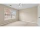 Neutral bedroom with a large window with blinds providing natural light and views of the neighborhood at 2055 Hickory Station Cir, Snellville, GA 30078