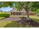Exterior shot of a brick home with a covered porch, showcasing the mature landscaping and inviting facade at 2055 Hickory Station Cir, Snellville, GA 30078