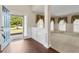 Bright entryway featuring wood flooring, detailed trim, and an open view to the adjacent living space at 2055 Hickory Station Cir, Snellville, GA 30078