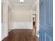 Elegant foyer with hardwood floors, wainscoting, and a view into the kitchen, creating a warm welcome at 2055 Hickory Station Cir, Snellville, GA 30078