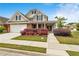 Beautiful home with a brick and tan exterior, complemented by well-maintained landscaping and a covered entry at 2055 Hickory Station Cir, Snellville, GA 30078