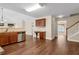 View of the kitchen with desk, open to the dining area and featuring hardwood floors at 2055 Hickory Station Cir, Snellville, GA 30078